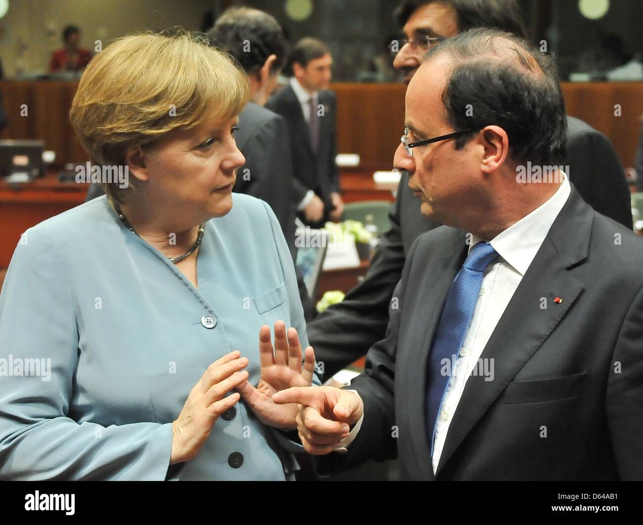 Germany's chancellor Angela Merkel and French president Francois Hollande greet during the EU summit in Brussels, Belgium, 23 May 2012. The heads of states and heads of governments of the 27 EU states have come together to speak about economical growth as a way out of the crisis. Topics discussed will be a possible tax on financial deals as well as eurobonds. Photo: Felix Kinderman Stock Photo