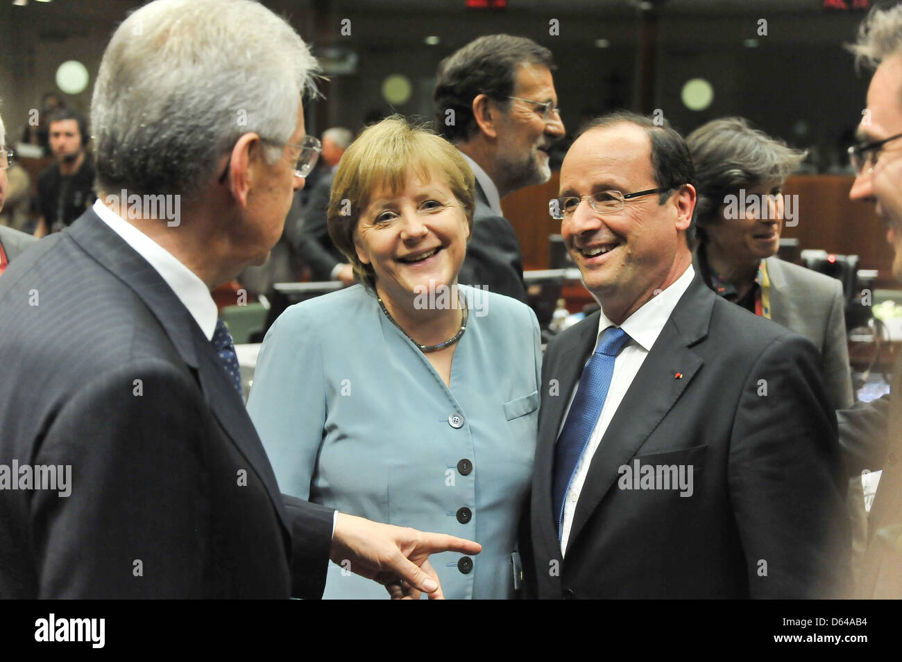 Italian minister of Finance Mario Monti (l), Germany's chancellor Angela Merkel and French president Francois Hollande greet during the EU summit in Brussels, Belgium, 23 May 2012. The heads of states and heads of governments of the 27 EU states have come together to speak about economical growth as a way out of the crisis. Topics discussed will be a possible tax on financial deals Stock Photo