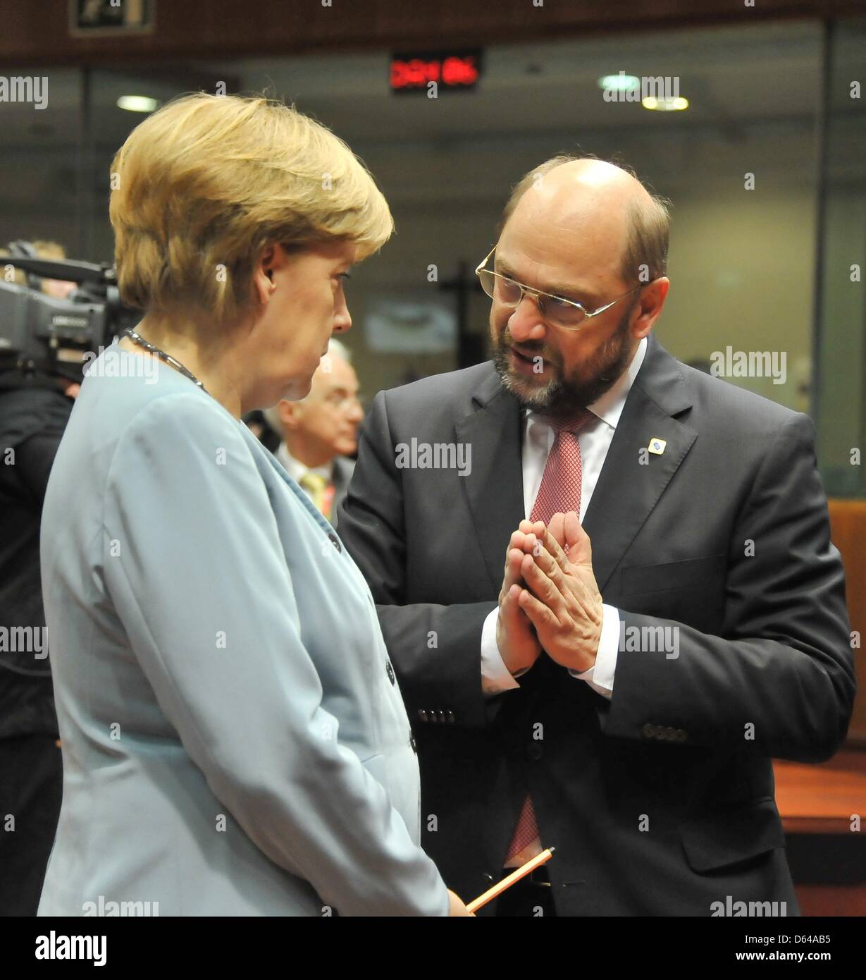 Germany's chancellor Angela Merkel the President of the EU Parliament Martin Schulz (SPD) speak during the EU summit in Brussels, Belgium, 23 May 2012. The heads of states and heads of governments of the 27 EU states have come together to speak about economical growth as a way out of the crisis. Topics discussed will be a possible tax on financial deals as well as eurobonds. Photo: Stock Photo
