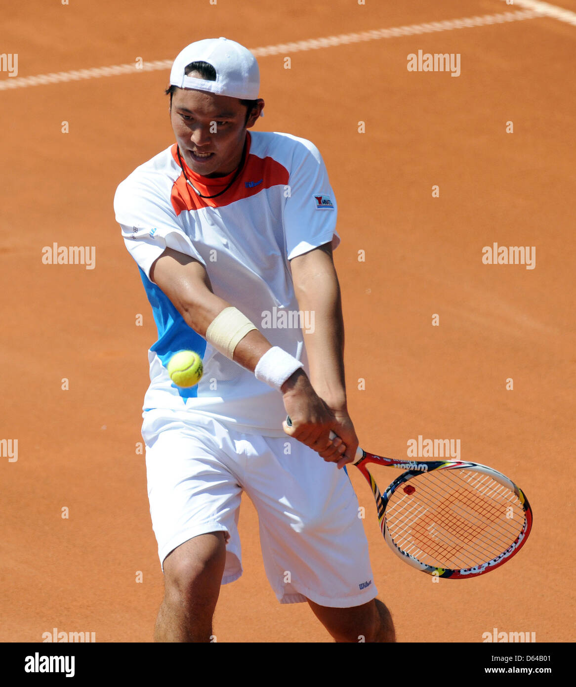 Japanese tennis player Tatsuma Ito hits the ball in a match against
