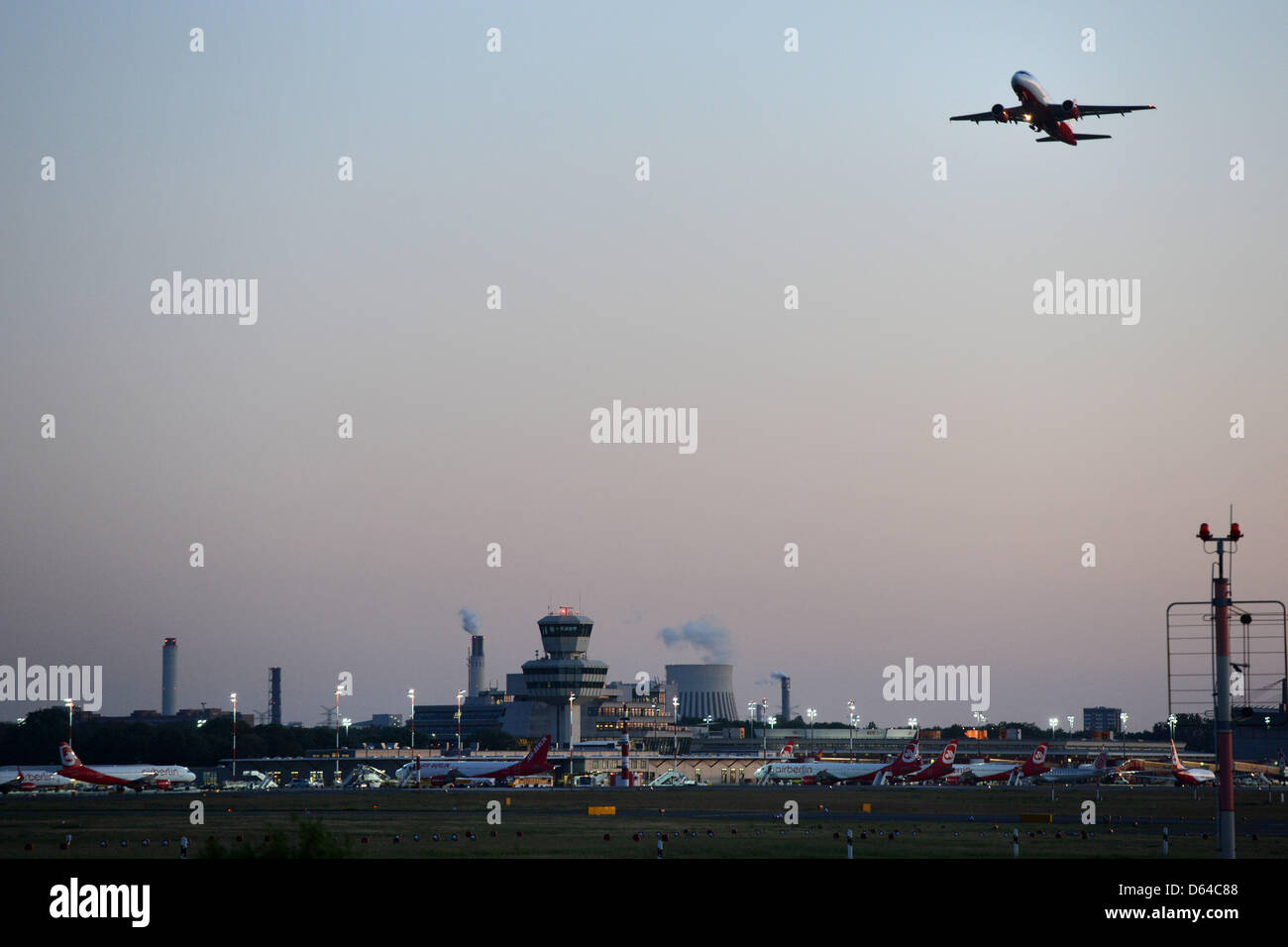 An airplane takes off at dusk at Tegel Airport in Berlin, Germany, 24 May 2012. There are discussions about admitting night flights in Tegel after the opening of the new Berlin International Airport (BER) had to be pushed back to 2013. Foto: Matthias Balk dpa/lbn Stock Photo