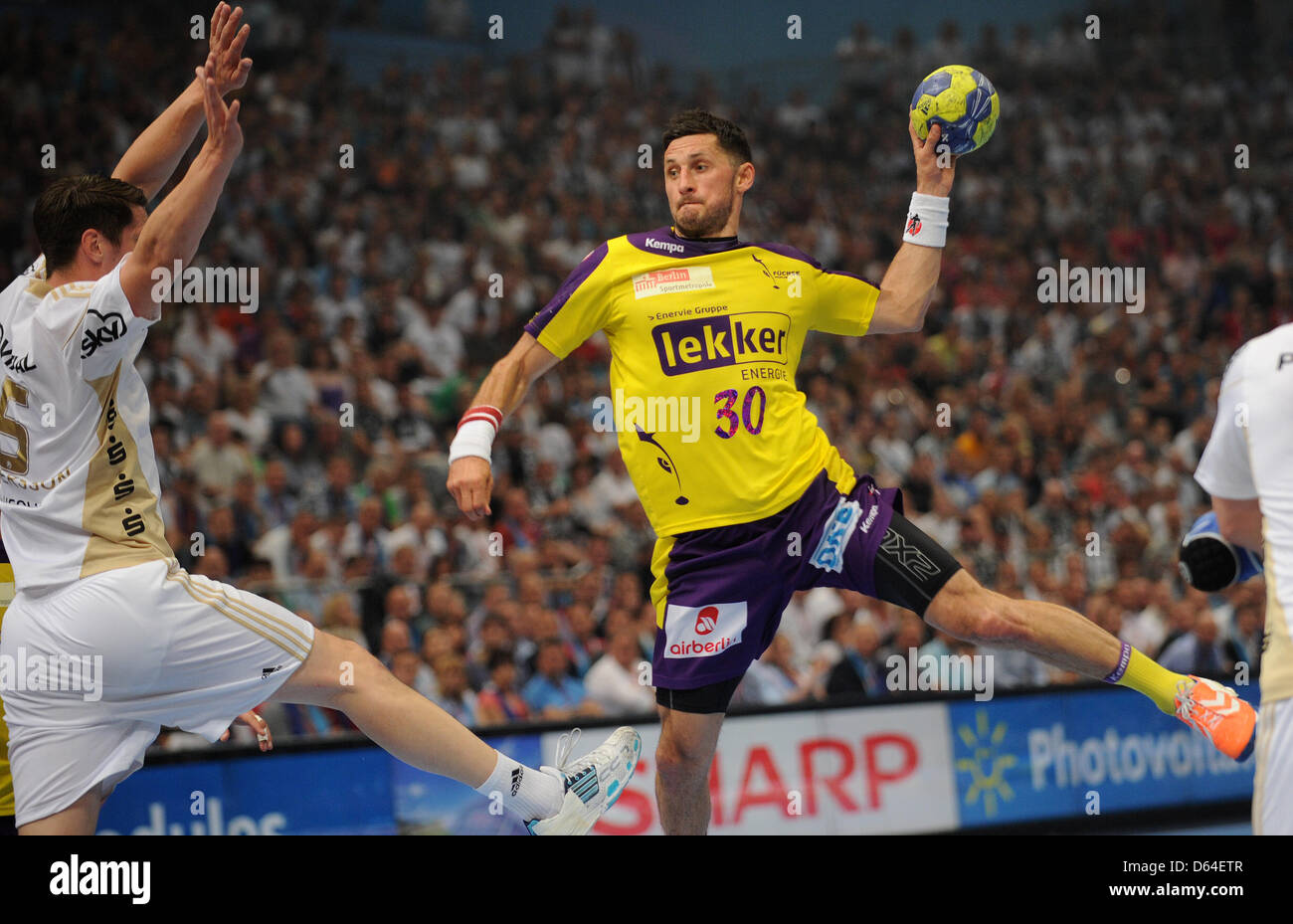 Berlin's Alexander Petersson tries to score a goal Kiel's Kim Andersson  during the EHF Champions League Final Four semi-final match between Fuechse  Berlin and THW Kiel at Lanxess Arena in Cologne, Germany,