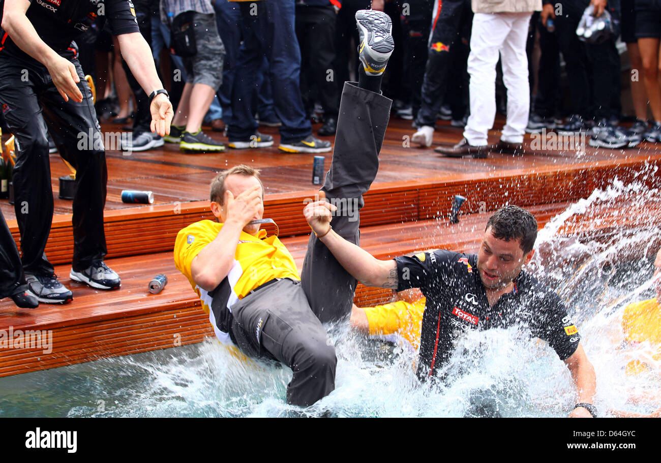 Team members from Bull jump into a swimming pool after winning the Grand Prix Monaco at the F1 race track of Monte Carlo circuit, in Monaco, 27 May 2012. Photo: