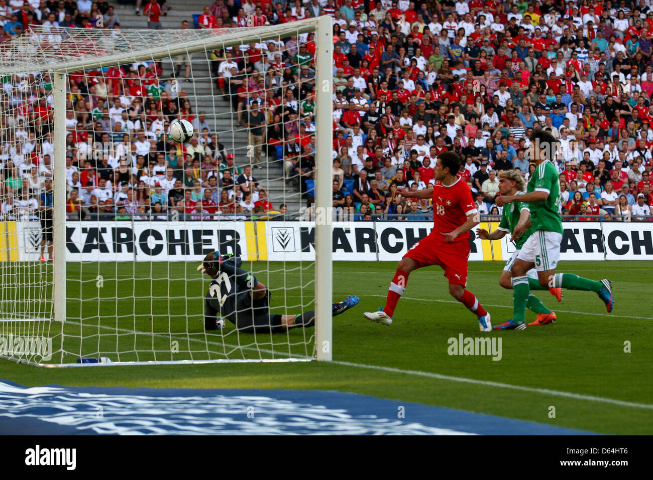 Switzerland's Admir Mehmedi (M) shoots the 3-1 against Germany's goalkeeper Marc-Andre ter Stegen (L) and Mats Hummels during the international friendly soccer match between Switzerland and Germany at St. Jakob Park in Basel, Switzerland, 26 May 2012. Photo: Revierfoto Stock Photo