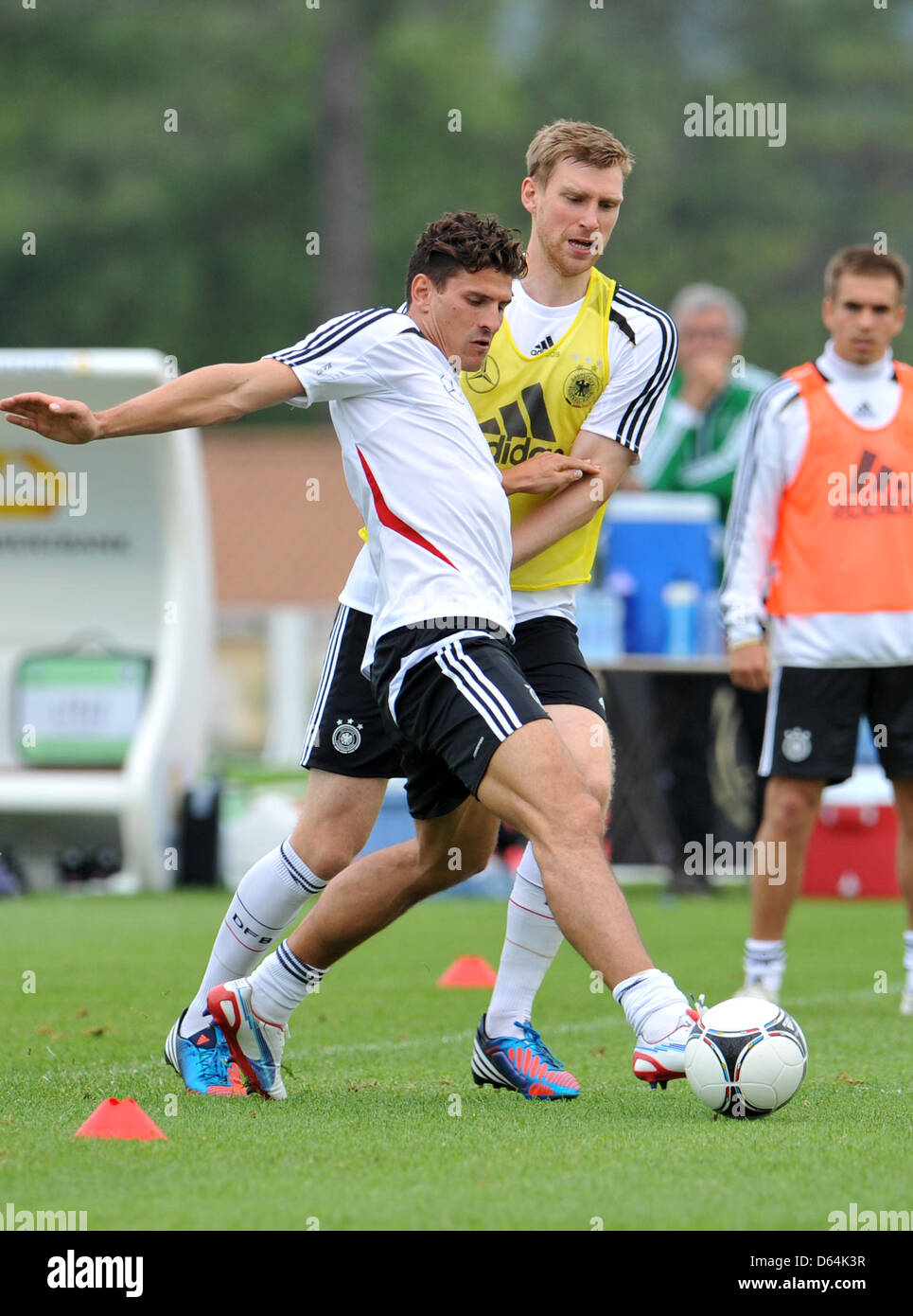 Germany's Per Mertesacker and Mario Gomez (L)  vie for the ball during practice on a pitch in Tourettes, France, 29 May 2012. The German national soccer team is preparing for the Euro 2012 at their training camp in southern France. Photo: ANDREAS GEBERT Stock Photo