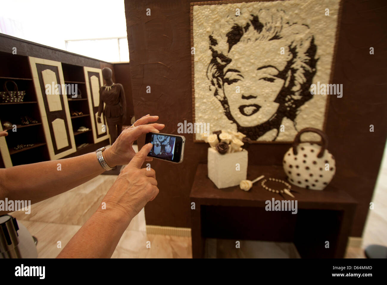 Adelaide, Australia. 12th April 2013. A member of the public takes a picture of Marilyn Monroe which is made  from chocolate by food artist and British chocolate maker Prudence Staite for the reopening of Adelaide's Rundle Mall. Credit: amer ghazzal / Alamy Live News Stock Photo