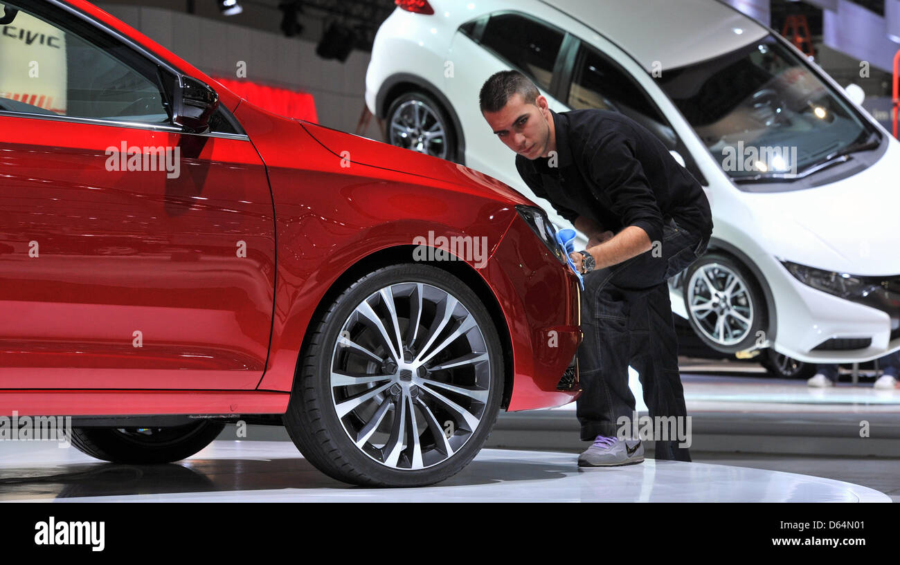An employee at the exhibition booth of car manufacturer Seat polishes a Toledo Concept which will celebrate its Germany Pemiere at the Auto Mobil International (AMI) which starts the day after tomorrow in Leipzig, Germany, 31 May 2012. All German car manufacturers and the majority of international car manufacturers will present their products. 450 exhibitors from 23 countries will  Stock Photo