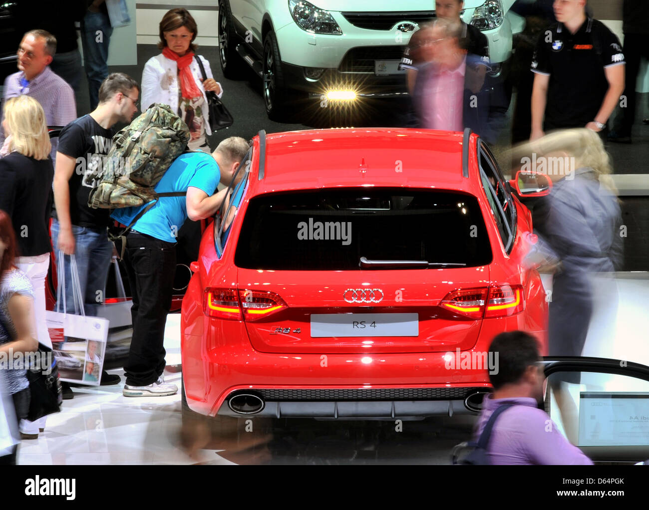 Visitors stroll around exhibited cars and motor vehicles of car manufacturer Audi at the automobile fair AMI in Leipzig, Germany, 2 January 2012. German and international car manufacturers present their latest car novelties at the Leipzig trade fair centre from 2 June to 10 June 2012. Around 280,000 visitors are expeocted to attend the fair which features up to 450 exhibitors. Phot Stock Photo