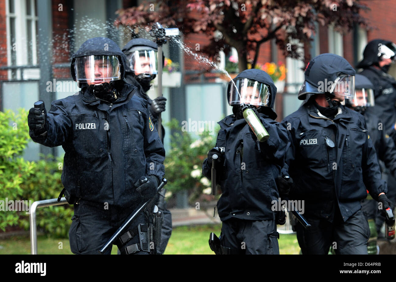Police officers use pepper spray during a demonstration against a march