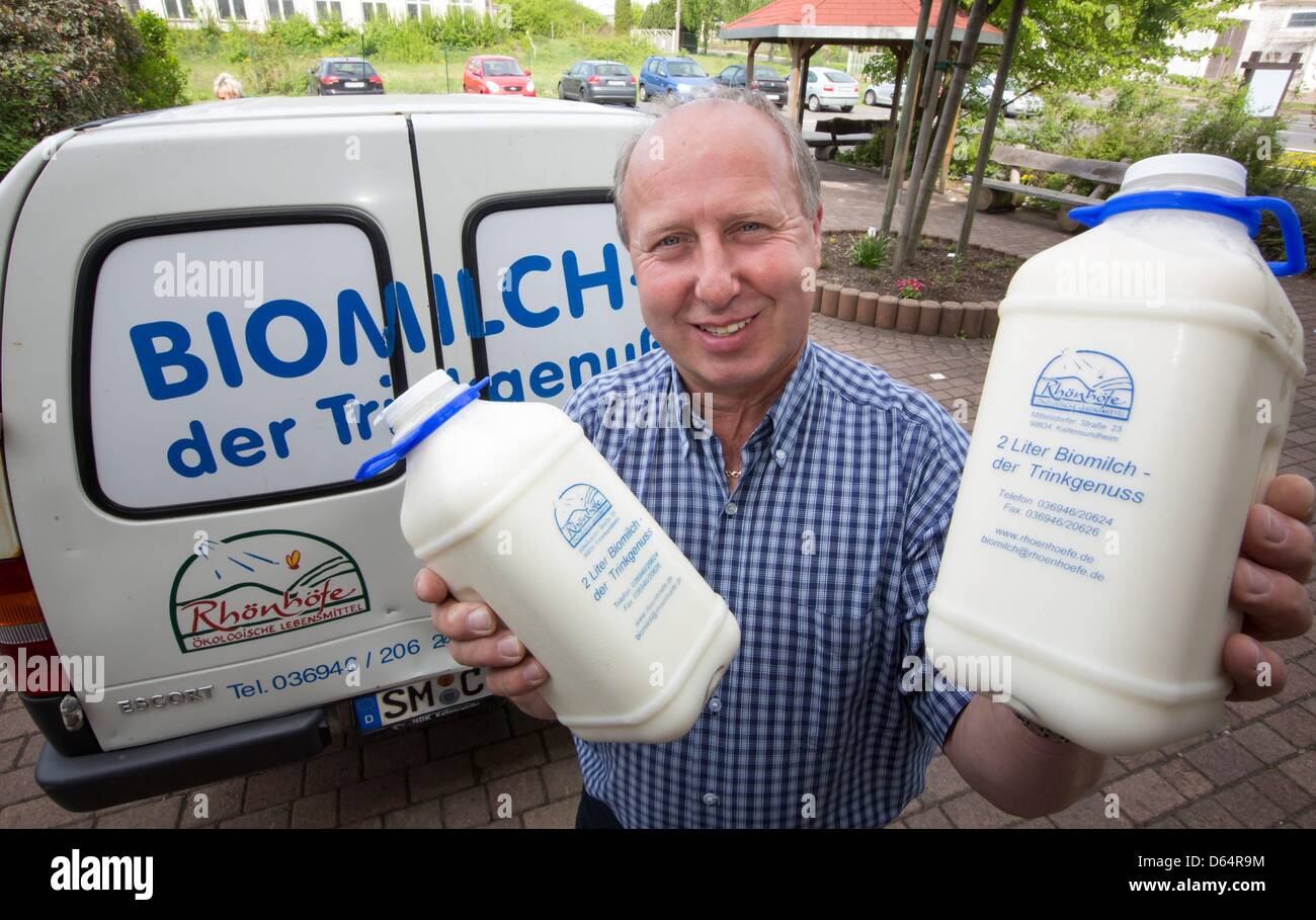 Edgar Gottbehuet, head of the dairy company Rhoenhoefe GmbH, presents  bottles of organic milk in Kaltensundheim, Germany, 11 May 2012. Just as  once the milkman brought milk to houses, company Rhoenhoefe delivers