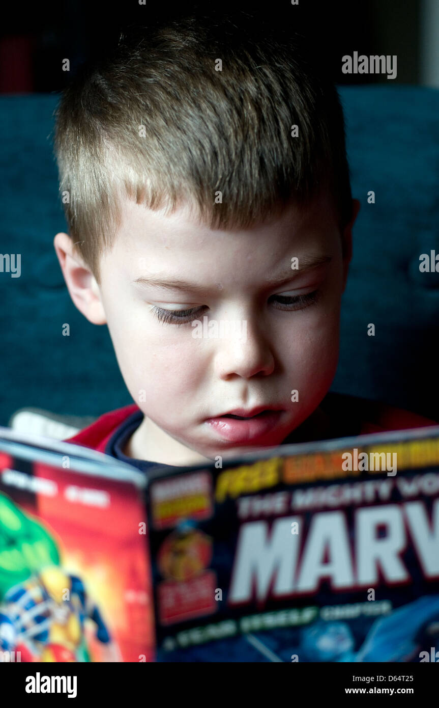Boy reading a marvel comic,comic, marvel,dress up, science fiction,marvel,comic, marvel, georgia, geek, halloween, labor day, fu Stock Photo