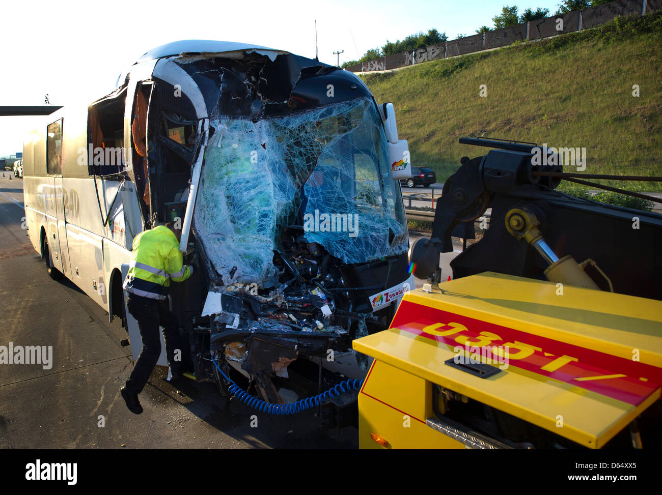 ADAC employees inspect a heavily damaged Polish bus on the autobahn A4 between Dresden Altenstadt and the Dresden junction, Germany, 06 June 2012. The bus collided with a truck for unknown reasons announced a police spokesperson. According to the fire department the passengers were able to leave the bus on their own. 25 passengers were taken to hospitals for treatment. 18 passenger Stock Photo