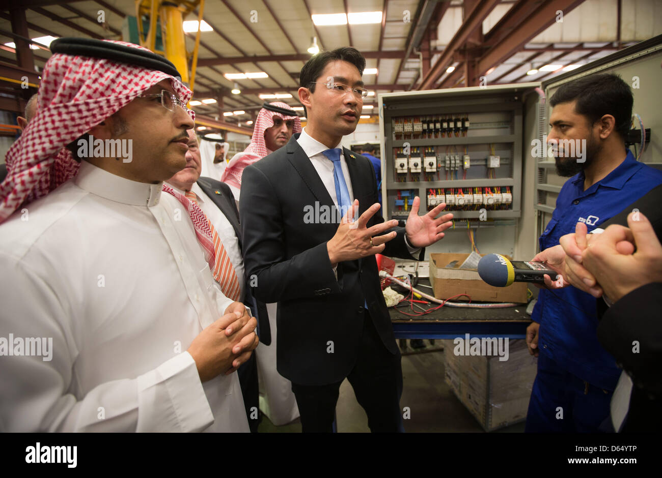 German Federal Minister of Economics Philipp Roesler (C) stands next to