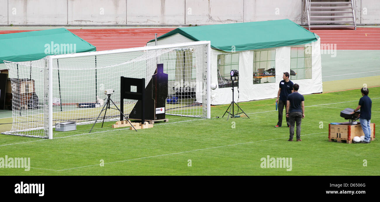 Employees of test institute Empa conduct tests on goal line recognition with a goal-kicking machine at Frankensatdion in Nuremberg, Germany, 07 June 2012. The question is wether the ball has crossed the goal line, or not. Soccer world association FIFA Fraunhofer Institute for Integrated Circuits (IIS) have publicly presented this new technology. The system was developed by IIS and  Stock Photo