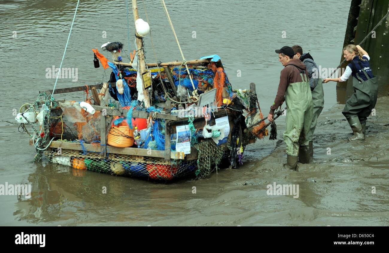 A raft made of marine garbage weighing around 300 kg is set afloat in