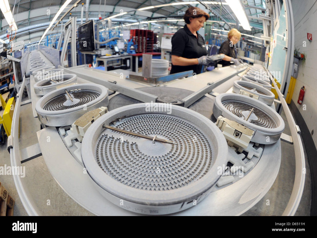 Staff conduct final checks on a set of heater elements at the manufacturing plant of German houshold supply company Elektro-Geraetebau GmbH Oberderdingen (E.G.O.) in Oberderdingen, Germany, 2 May 2012. Photo: Uli Deck Stock Photo