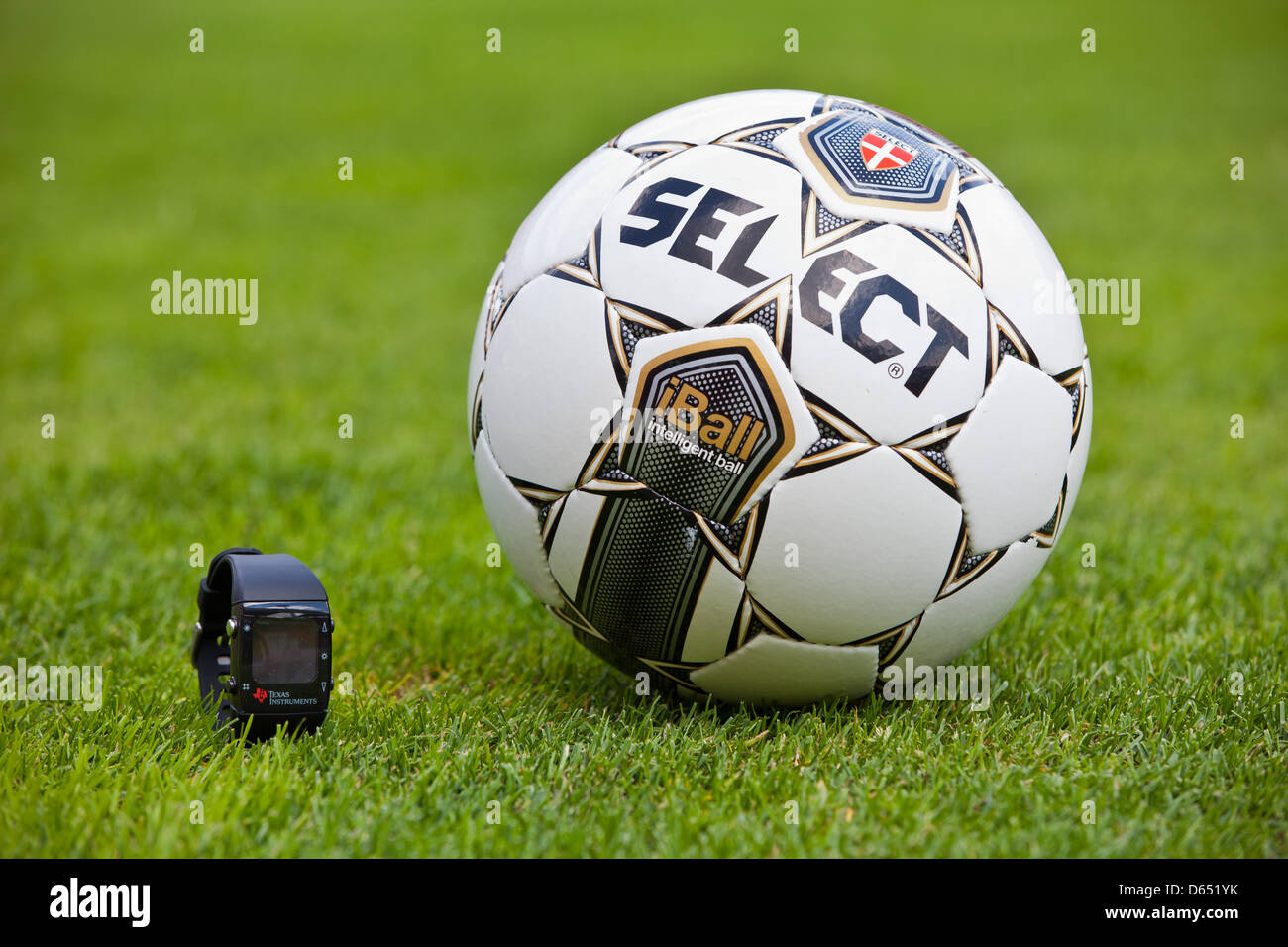 A test ball equipped with a chip and the associated radio watch lie on the pitch of Frankenstadion in Nuremberg, Germany, 07 June 2012. The question is wether the ball has crossed the goal line, or not. Soccer world association FIFA Fraunhofer Institute for Integrated Circuits (IIS) have publicly presented this new technology. The system was developed by IIS and Danish company Goal Stock Photo