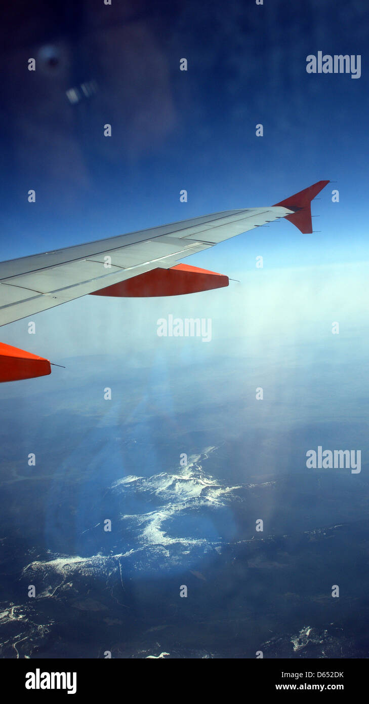 alps snow plane flying atmosphere sun earth wing panels blue sky night sky Stock Photo