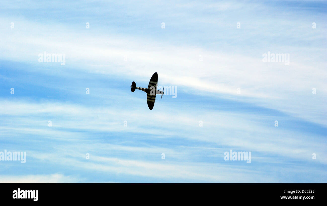 spitfire flying clouds blue sky Stock Photo