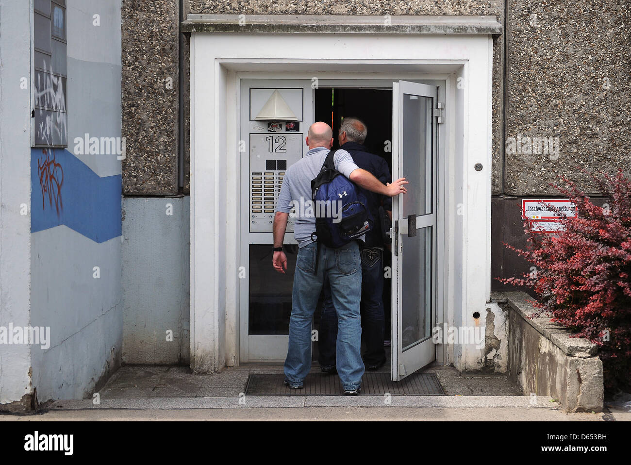 Officers of the criminal investigation department walk into a building ...