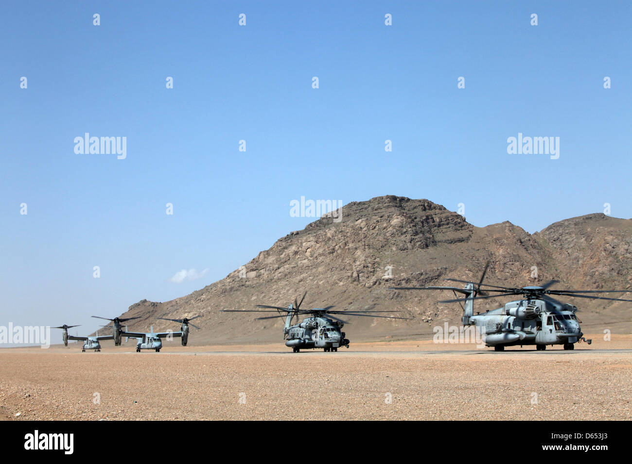 US Marine Corps CH-53E Super Stallion helicopters and Osprey tilt rotor aircraft ready for a joint military operation of US, British and Afghan forces April 11, 2013 in Helmand province, Afghanistan. Stock Photo