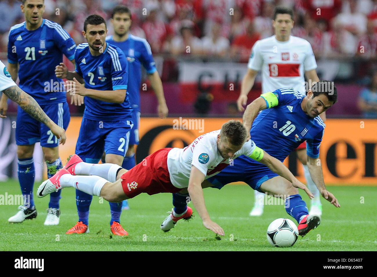 Poland's Jakub Blaszczykowski (L) vies for the ball with Greece's Giorgos Karagounis (R) during the UEFA Euro 2012 match between Poland and Greece at the national stadium in Warsaw, Poland, 08 June 2012. Photo: Pressfocus / Revierfoto Stock Photo