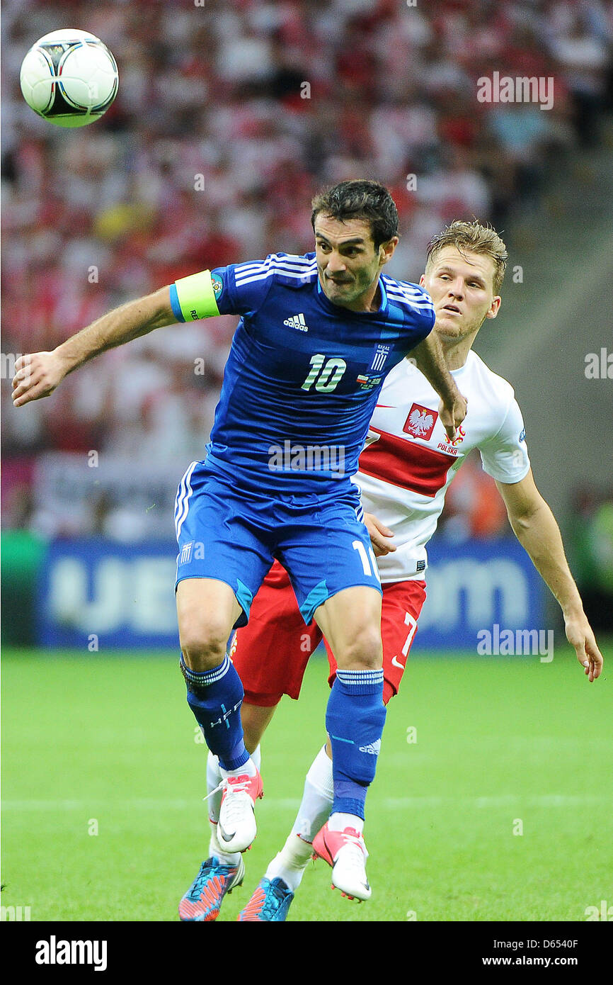 Poland's Eugen Polanski (R) vies for the ball with Greece's Giorgos Karagounis (front) during the UEFA Euro 2012 match between Poland and Greece at the national stadium in Warsaw, Poland, 08 June 2012. Photo: Pressfocus / Revierfoto Stock Photo