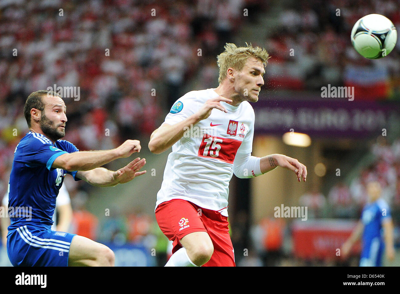 Poland's Damien Perquis (R) vies for the ball with Greece's Dimitris Salpingidis during the UEFA Euro 2012 match between Poland and Greece at the national stadium in Warsaw, Poland, 08 June 2012. Photo: Pressfocus / Revierfoto Stock Photo