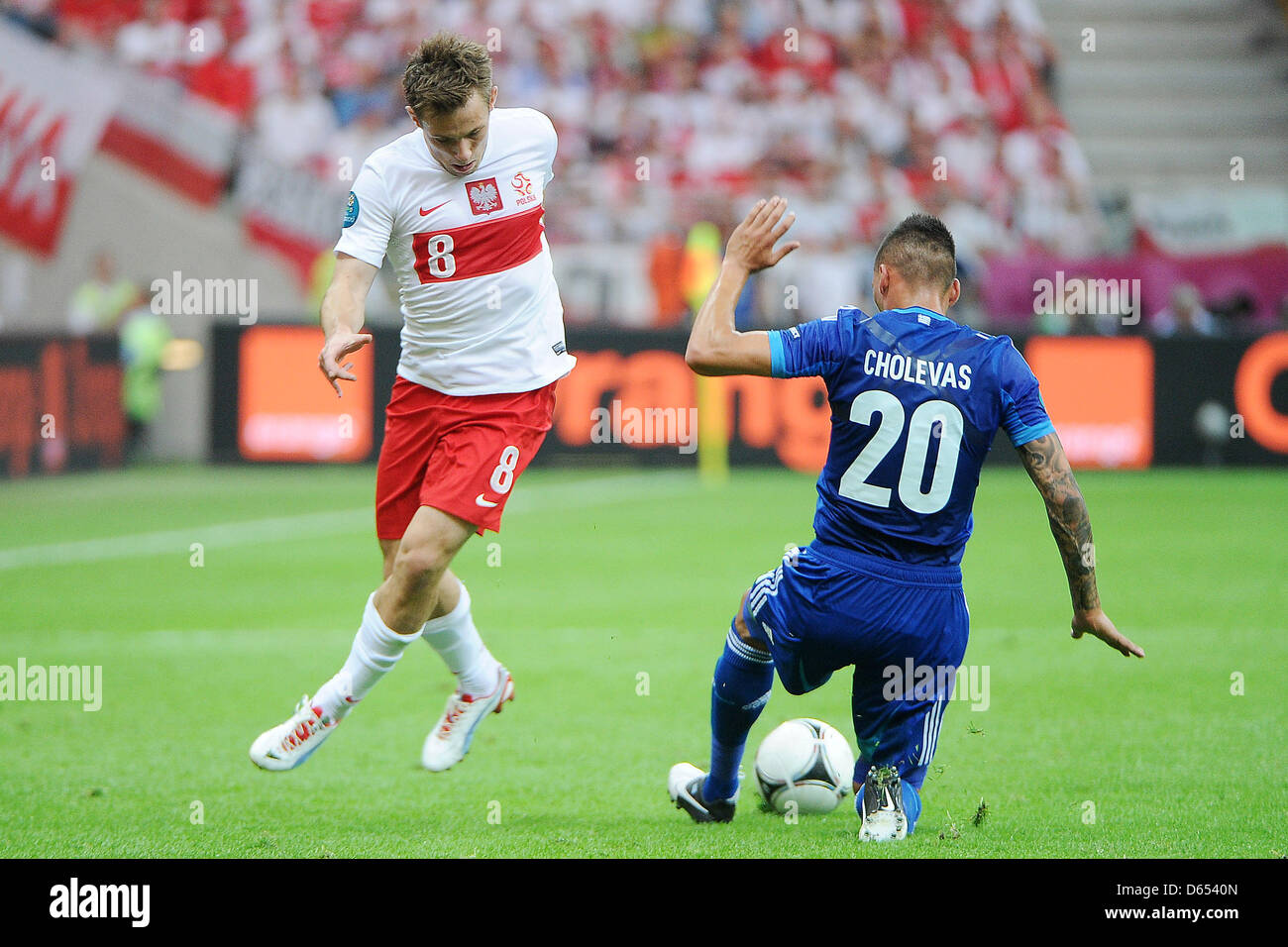Poland's Maciej Rybus (L) vies for the ball with Greece's Jose Holebas during the UEFA Euro 2012 match between Poland and Greece at the national stadium in Warsaw, Poland, 08 June 2012. Photo: Pressfocus / Revierfoto Stock Photo
