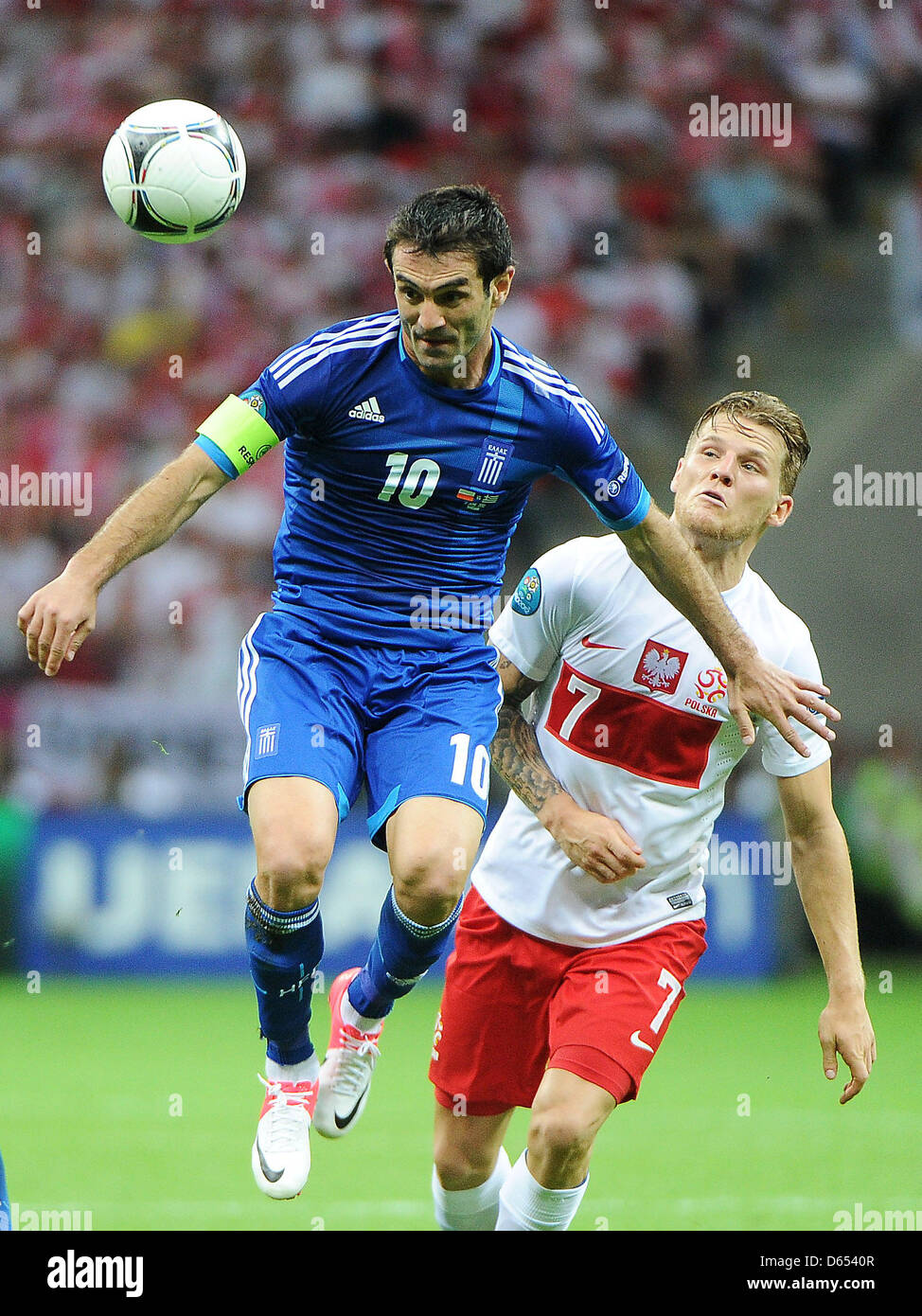 Poland's Eugen Polanski (R) vies for the ball with Greece's Giorgos Karagounis during the UEFA Euro 2012 match between Poland and Greece at the national stadium in Warsaw, Poland, 08 June 2012. Photo: Pressfocus / Revierfoto Stock Photo