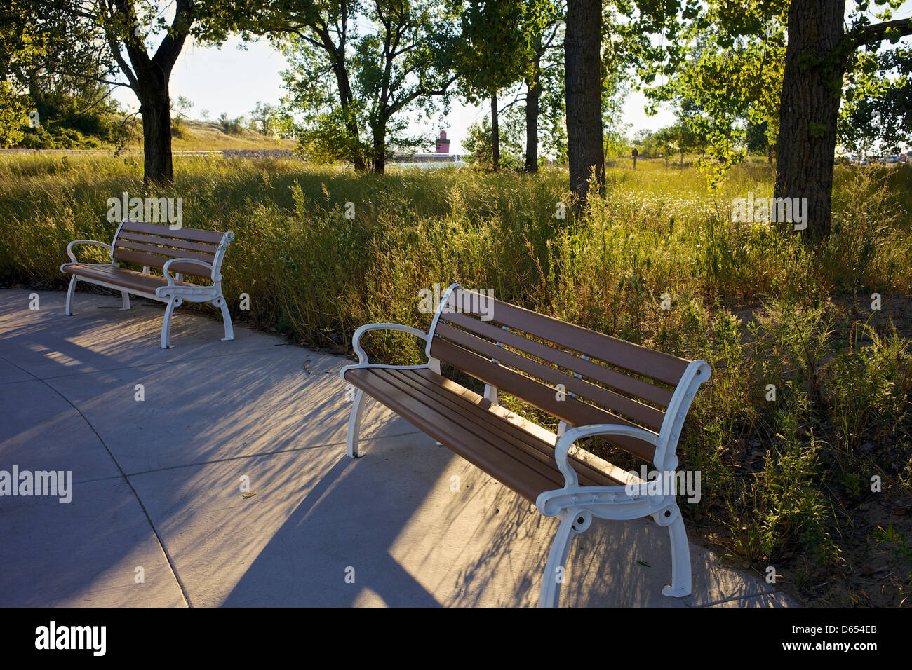 Park benches near Holland State Park with the "Big Red" lighthouse in