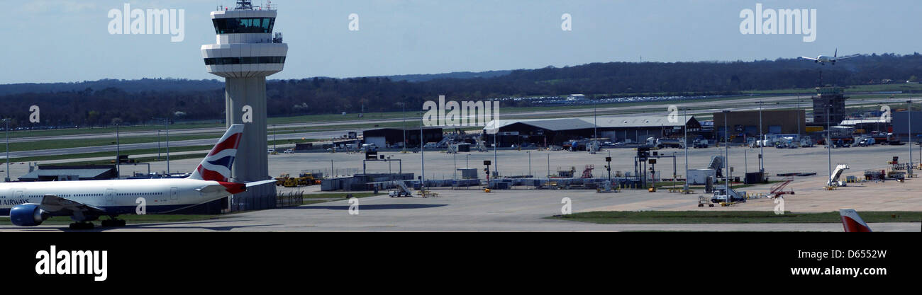 gatwick airport runway biritish airways plane taxiing landing plane ATC hangers Stock Photo