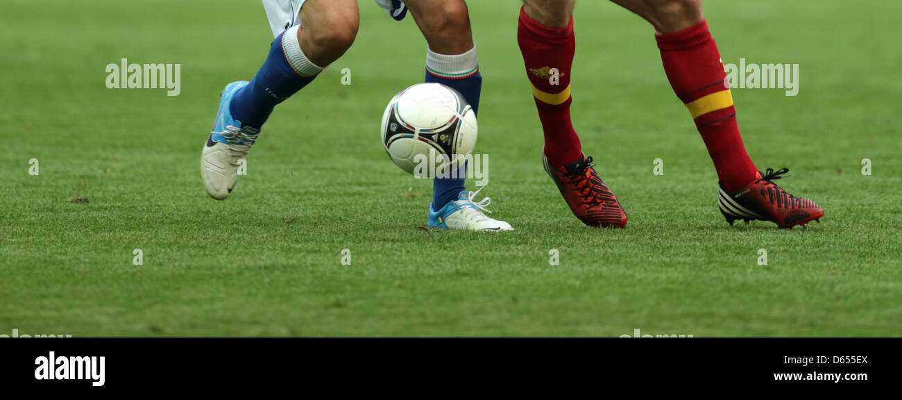 The feet of an italian (l) and a spanish player are seen as they fight for  the ball during UEFA EURO 2012 group C soccer match Spain vs Italy at Arena  Gdansk