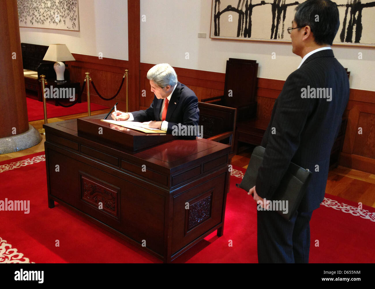 US Secretary of State signs a guest book upon his arrival at The Blue House, the office and residence of Republic of Korea President Park Guen-hye April 12, 2013 in Seoul, South Korea. Stock Photo