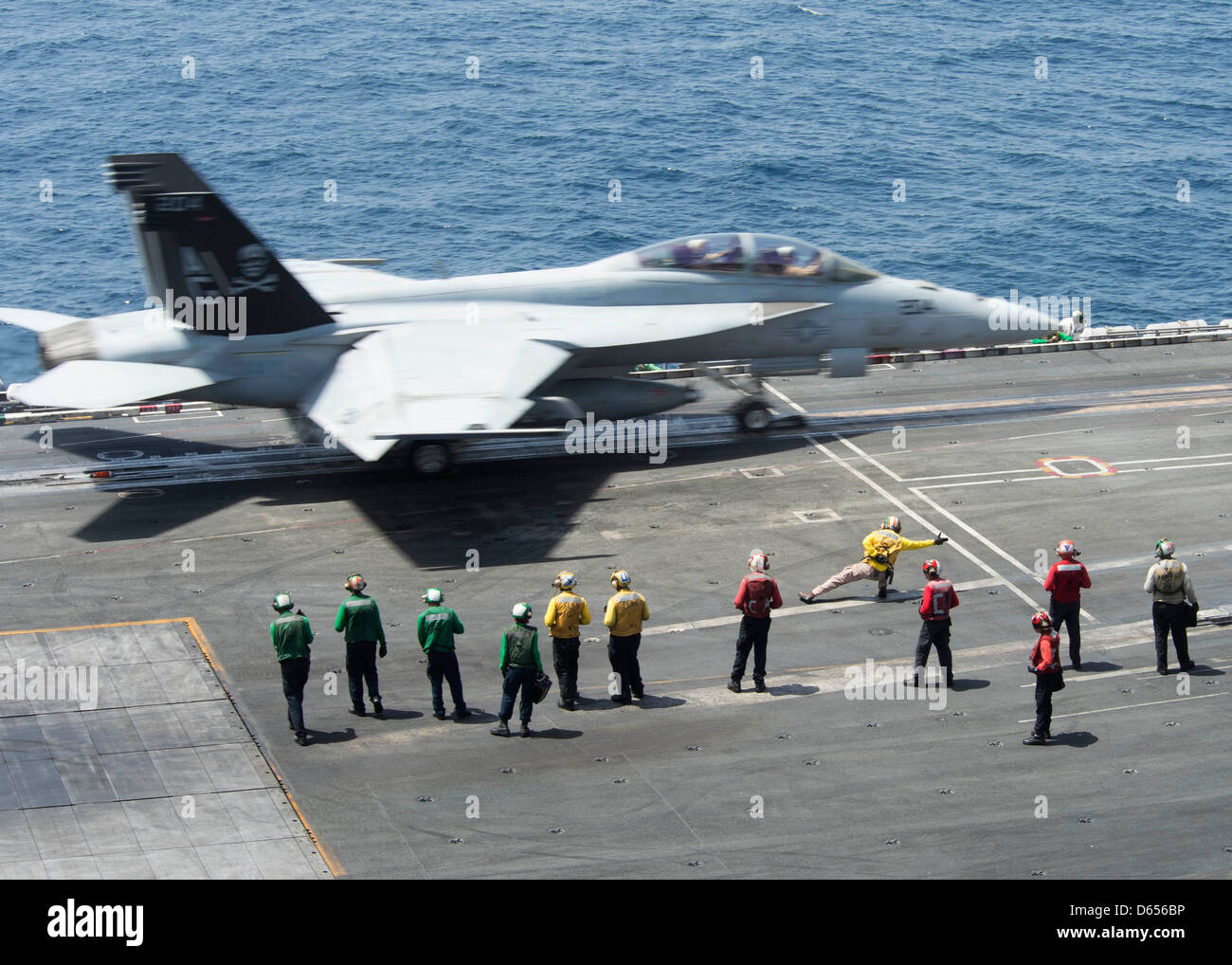 a-us-navy-fa-18c-hornet-launches-from-the-flight-deck-of-aircraft-D656BP.jpg