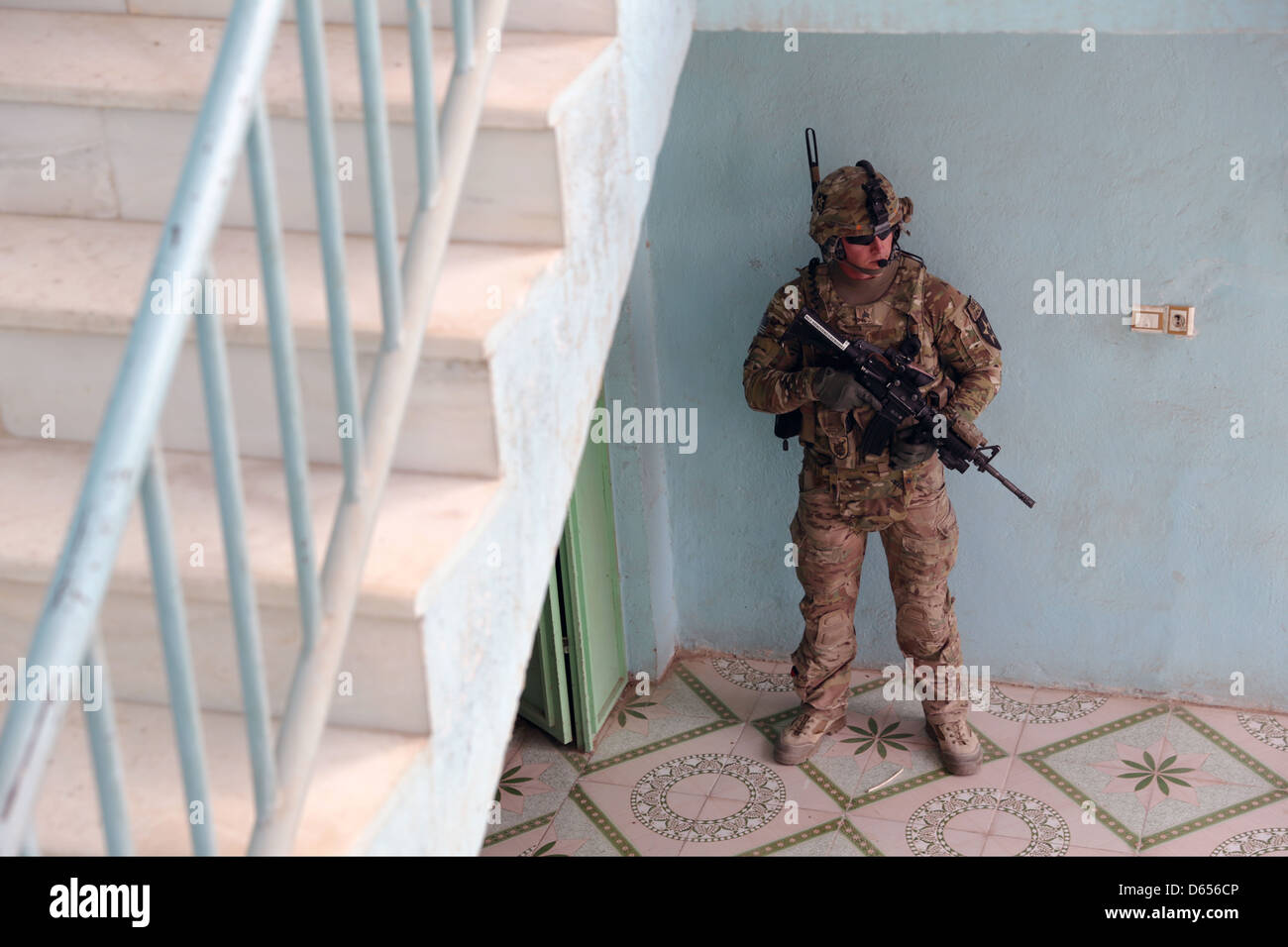 A US Army soldier assigned to the Farah Provincial Reconstruction Team security force provides security April 10, 2013 in Farah city, Farah province, Afghanistan. Stock Photo