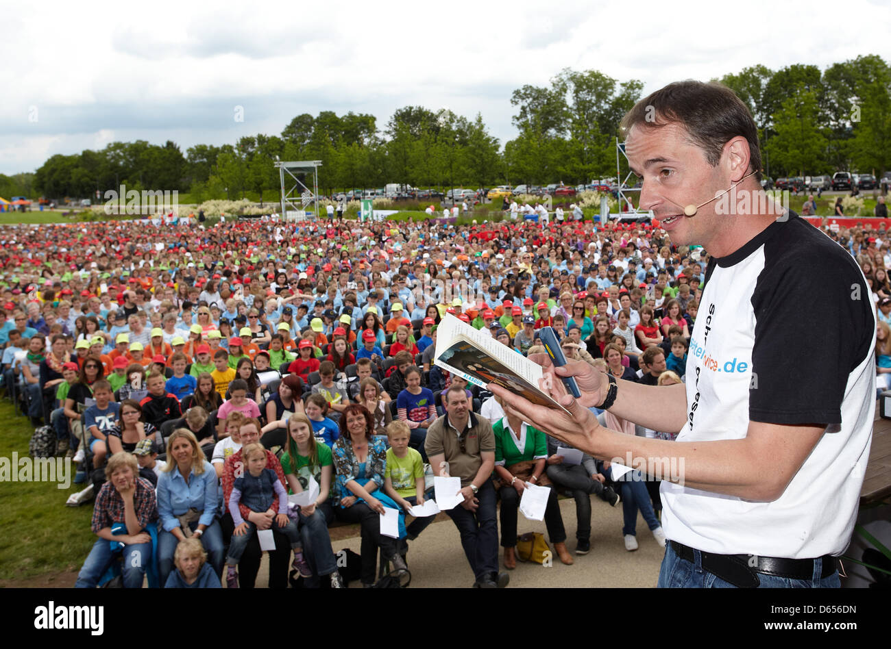 Children's book author Stefan Gemmel reads to more than 5,000 children behind Ehrenbreitstein Fortress in Koblenz, Germany, 12 June 2012. He set a new world record for a reading by a single author to the largest audience in the 'Guiness Book of World Records'. Photo: THOMAS FREY Stock Photo