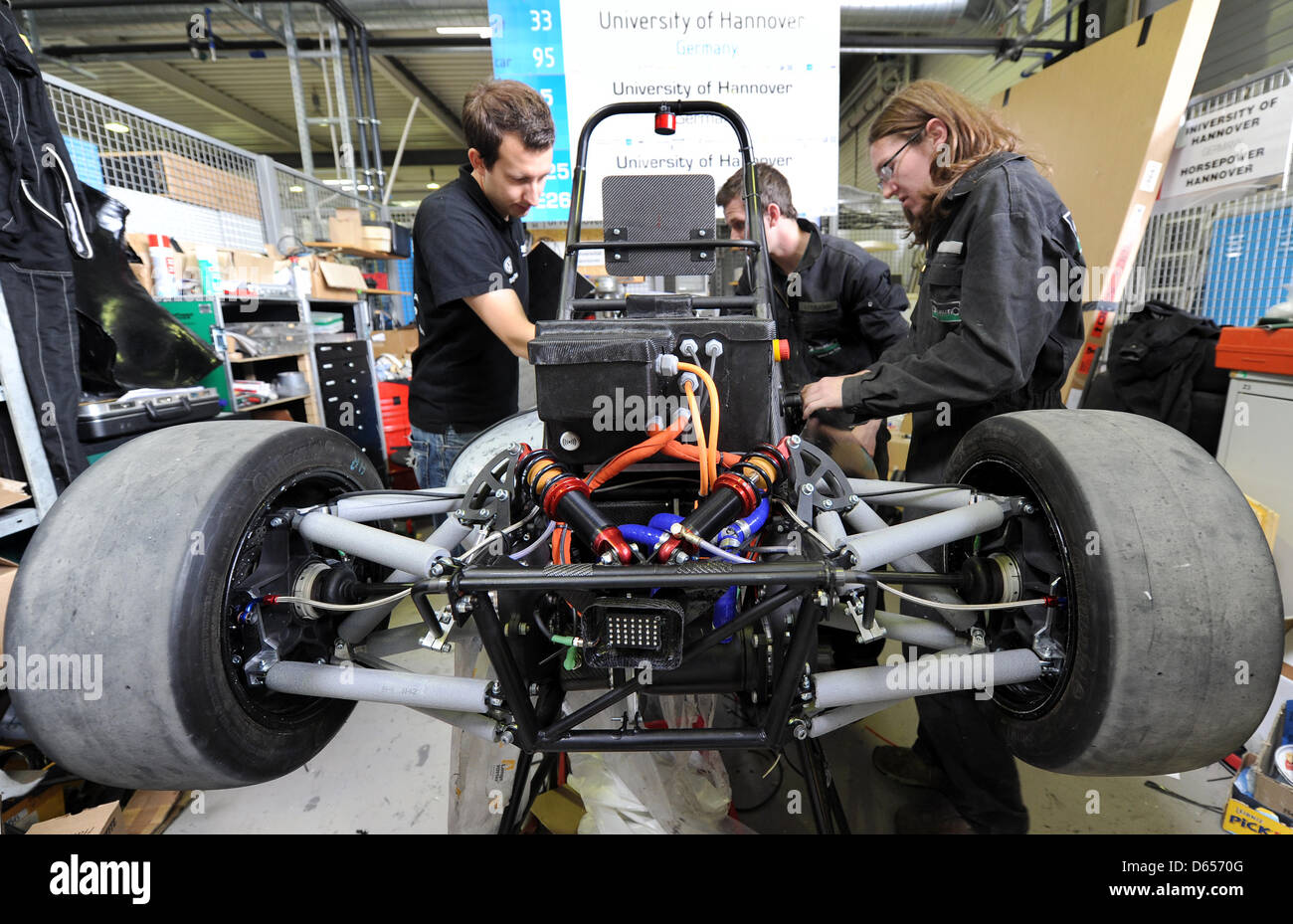 Students of the Formula Student team of Leibniz University Hanover work on their new 'Electric Horse 2012' race car in Hanover, Germany, 12 June 2012. The race car is black, weighs around 220 kg and has 114 horsepower. It is powered solely by electricity and will compete in the international construction competition at the English race track in Silverstone. Around 60 students have  Stock Photo