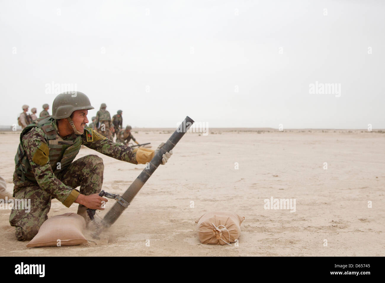 Afghan National Army soldier fires the M224 mortar system during live fire training April 8, 201 at Camp Shorabak, Helmand province, Afghanistan. Stock Photo