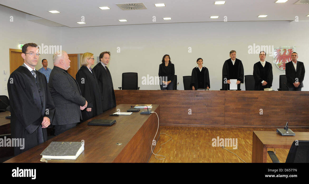 A court bailiff shows hotelier Axel Hilpert (2 L) awaits the verdict in A court bailiff shows hotelier Axel Hilpert (2 L) awaits the verdict in