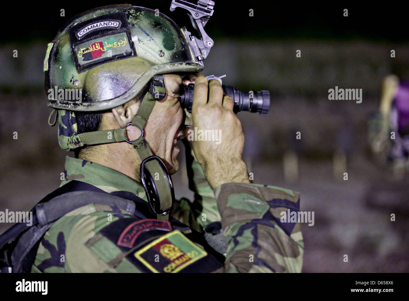 An Afghan National Army commando with the 1st Special Operations Kandak looks through night vision goggles during training April 8, 2013 in Behsud district, Nangarhar province, Afghanistan. Stock Photo