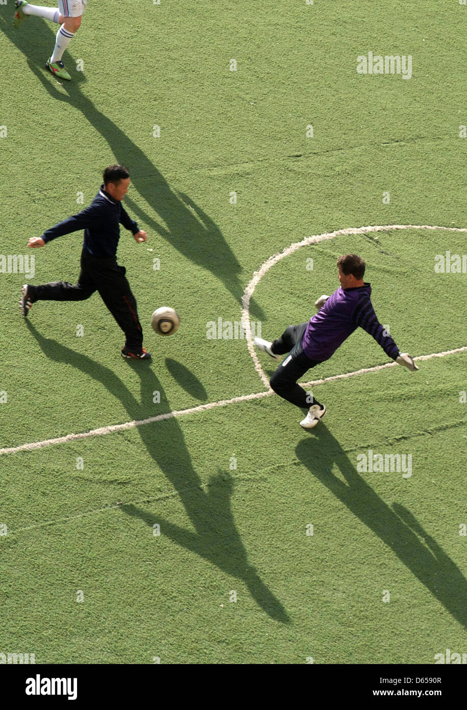 Mongolian recreational soccer players attend their weekly training session at a soccer field in the center of Ulan Bator, Mongolia, 11 June 2012. Many Mongolians are avid soccer fans and keenly follow the UEFA Euro 2012 in Ukraine and Poland. Photo: Nicole Graaf Stock Photo