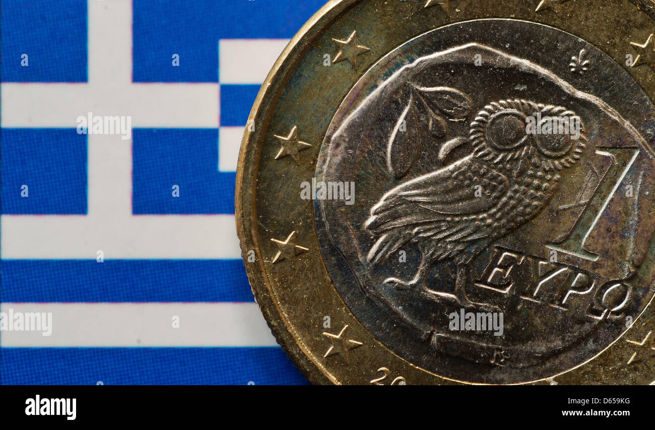 A Greek Euro coin is pictured on a Greek national flag in Frankfurt