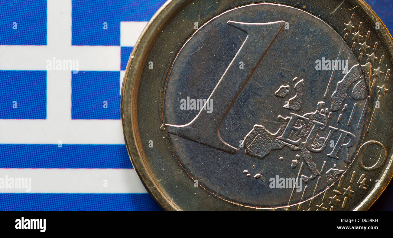 A Greek Euro coin is pictured on a Greek national flag in Frankfurt