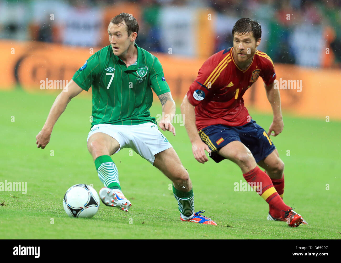 Spain's Xabi Alonso and Ireland's Aiden McGeady (L) vie for the ball during UEFA EURO 2012 group C soccer match Spain vs Italy at Arena Gdansk in Gdansk, Poland, 14 June 2012. Photo: Jens Wolf dpa (Please refer to chapters 7 and 8 of http://dpaq.de/Ziovh for UEFA Euro 2012 Terms & Conditions)  +++(c) dpa - Bildfunk+++ Stock Photo