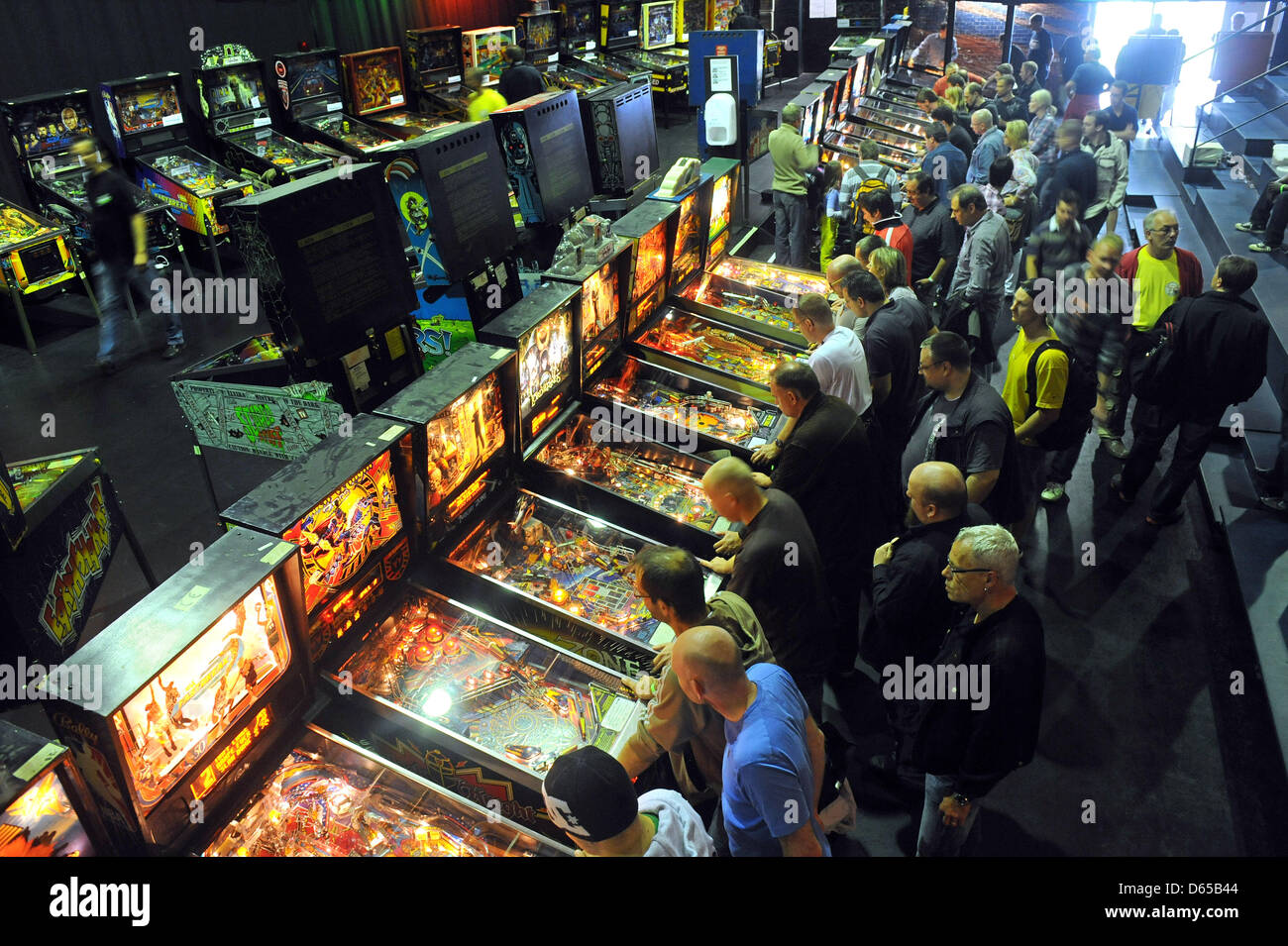 Competitors practice playing pinball prior to the German Pinball
