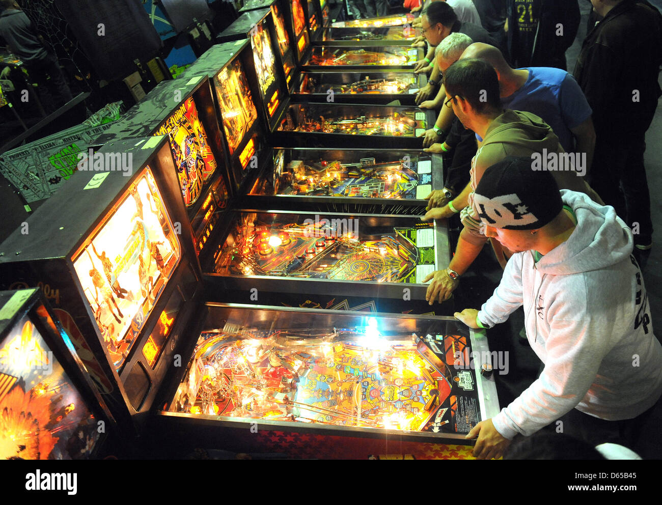 Competitors practice playing pinball prior to the German Pinball