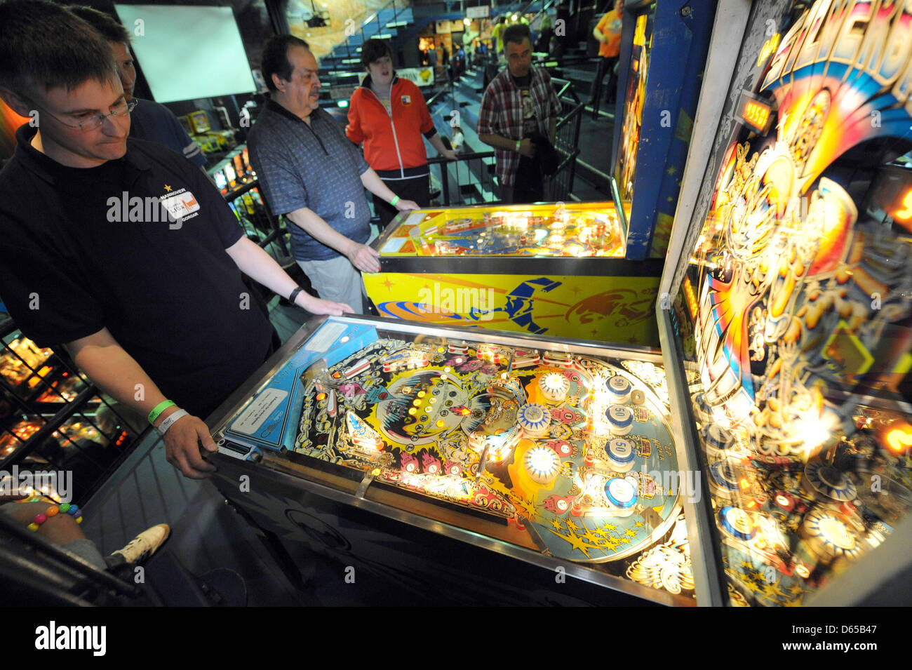 Competitors practice playing pinball prior to the German Pinball Championship, which takes place at the same venue in the evening, at Schlachthof in Bremen, Germabny, 16 June 2012. In a few hours from then, the new German 'Pinball Wizzard 2012' will be clear. Photo: INGO WAGNER Stock Photo