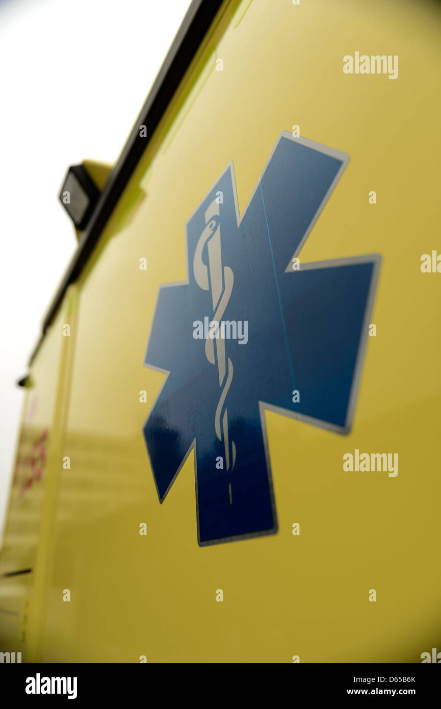 Blue star paramedics symbol on yellow ambulance car Stock Photo