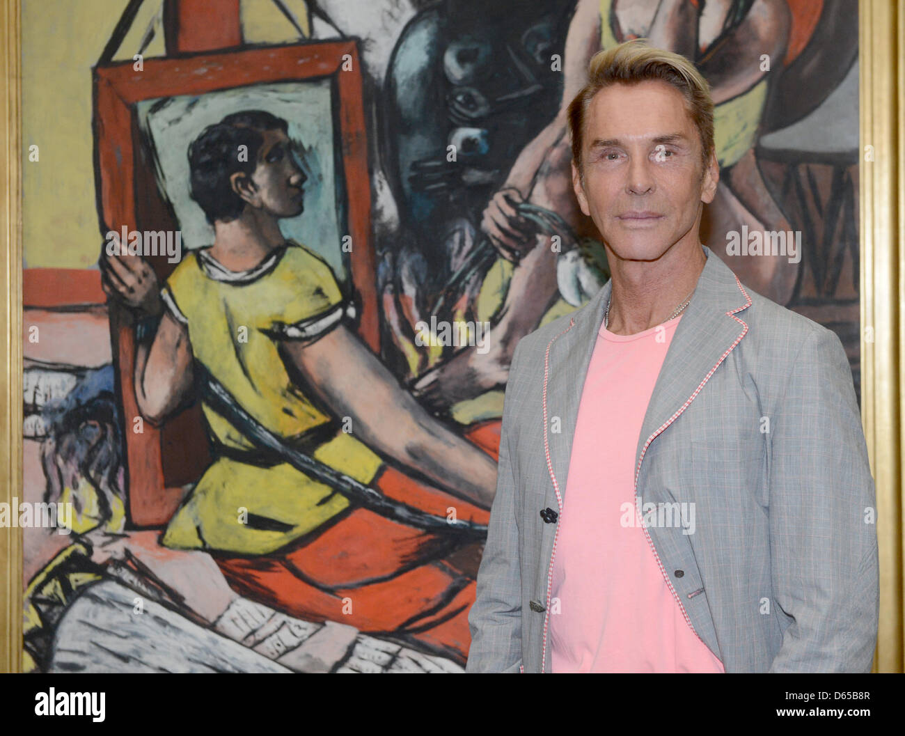 German fashion designer Wolfgang Joop poses in front of the painting Temptation (the temptation of saint anthony) by Max Beckmann at the exhibition FRAUEN (women) at the Pinakothek in Munich, Germany, 15 June 2012. Photo: Felix Hoerhager Stock Photo